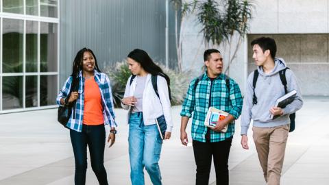 four college students walking and talking