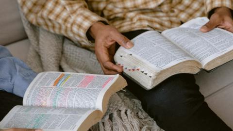 https://www.pexels.com/photo/two-people-reading-bible-while-sitting-on-a-sofa-6860819/