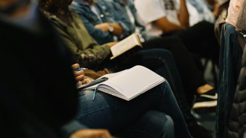 Image of a group of people reading biblical text and taking notes. Courtesy of Unsplash.