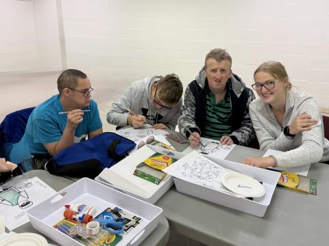 A group of people at Friendship Ministry working on a craft