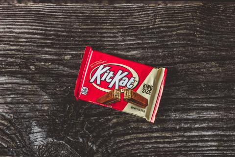 An image of a KitKat bar on a background of wood